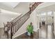 Grand foyer with hardwood floors, elegant staircase, and views of the living room at 1527 Canyon Oak Ln, Columbus, IN 47201