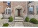 Charming front entrance with brick facade, stone accents, and manicured shrubs at 1527 Canyon Oak Ln, Columbus, IN 47201