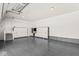 Spacious garage with epoxy flooring, white cabinets, and ample storage space at 1527 Canyon Oak Ln, Columbus, IN 47201