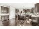 Modern kitchen with dark wood cabinets, granite countertops, and stainless steel appliances at 1527 Canyon Oak Ln, Columbus, IN 47201