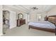 Spacious primary bedroom features a trey ceiling, ceiling fan, ensuite access, and walk-in closet at 1527 Canyon Oak Ln, Columbus, IN 47201