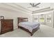Bright primary bedroom with tray ceilings, ceiling fan, dresser, large bed and bay window at 1527 Canyon Oak Ln, Columbus, IN 47201