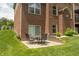 Outdoor patio with a table and chairs set, perfect for relaxing and enjoying the view of the landscaped yard at 1527 Canyon Oak Ln, Columbus, IN 47201