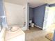 A dated bathroom features a sink, tub/shower combo, and toilet awaiting modern renovation at 1546 S New Jersey St, Indianapolis, IN 46225
