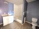 An outdated bathroom features vanity sink, toilet, and tub/shower combo at 1546 S New Jersey St, Indianapolis, IN 46225