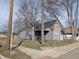 A quaint house featuring a classic gray siding and a dark roof, nestled between mature trees on a corner lot at 1546 S New Jersey St, Indianapolis, IN 46225