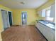 Spacious yellow kitchen with laminate flooring and ample counter space at 1546 S New Jersey St, Indianapolis, IN 46225