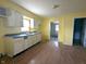 Bright yellow kitchen featuring ample counter space, cabinets, and a double sink under a window at 1546 S New Jersey St, Indianapolis, IN 46225