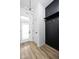 Inviting entryway featuring light wood floors, stylish light fixture, and dark wood built-ins with gold hooks at 17354 Newton Main St, Westfield, IN 46074