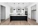 Modern kitchen with a large island, pendant lighting, and stainless steel appliances, perfect for culinary enthusiasts at 17354 Newton Main St, Westfield, IN 46074