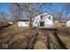 View of the house's backyard with a patio, lawn area, and a fence that surrounds the property at 1808 Raible Ave, Anderson, IN 46011