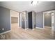 The hallway is well-lit with wood floors and access to multiple rooms at 1808 Raible Ave, Anderson, IN 46011