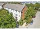 Aerial view showcasing the brick-and-white exterior, balcony, and mature trees surrounding the property at 2183 Glebe St, Carmel, IN 46032