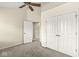 Cozy bedroom with neutral walls, carpet, closet and ceiling fan, providing comfort and functionality at 2183 Glebe St, Carmel, IN 46032