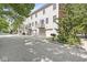 A three-story home with multiple balconies and street view, featuring attached garages and mature trees at 2183 Glebe St, Carmel, IN 46032