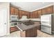 Contemporary kitchen with stainless steel appliances, dark cabinets, and a kitchen island at 2183 Glebe St, Carmel, IN 46032