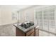 Open kitchen featuring dark wood cabinets, a center island, and large windows for natural light at 2183 Glebe St, Carmel, IN 46032