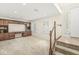 Bright, carpeted living room featuring built-in shelving and a staircase with wooden banister at 2183 Glebe St, Carmel, IN 46032