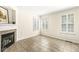 Cozy living room featuring tiled floors, a fireplace, and shuttered windows for natural light at 2183 Glebe St, Carmel, IN 46032