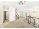Spacious living room area with neutral walls, a staircase, and plenty of natural light at 2183 Glebe St, Carmel, IN 46032