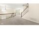 Bright open space features stairs, neutral walls, and large windows for natural light at 2183 Glebe St, Carmel, IN 46032
