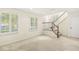 Inviting living room with large windows and a staircase, offering ample natural light at 2183 Glebe St, Carmel, IN 46032