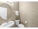 Elegant powder room with stylish wallpaper, a pedestal sink, and a modern toilet at 2183 Glebe St, Carmel, IN 46032