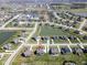 Wide aerial shot of a residential area with pond featuring a two-story home marked with a red location pin at 2314 Angelina Way, Greenwood, IN 46143