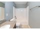The bathroom features a white toilet and a shower and tub with a white surround and a granite-look countertop on vanity at 2314 Angelina Way, Greenwood, IN 46143