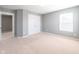 Bedroom featuring neutral carpet, large window and a closet with a set of double doors at 2314 Angelina Way, Greenwood, IN 46143