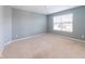 Simple bedroom with neutral carpet and a large window offering lots of natural light at 2314 Angelina Way, Greenwood, IN 46143