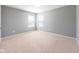 This bedroom has neutral carpeting, a ceiling light, and two windows dressed with white blinds to allow for natural light at 2314 Angelina Way, Greenwood, IN 46143