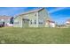The back exterior of a two-story home showcases a spacious yard and attached two car garage at 2314 Angelina Way, Greenwood, IN 46143