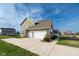 The side exterior reveals a lush lawn, the attached three car garage, and mature landscaping at 2314 Angelina Way, Greenwood, IN 46143