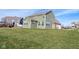 A side-angle exterior of a home boasts a large yard, showcasing its well-maintained landscape and architectural details at 2314 Angelina Way, Greenwood, IN 46143