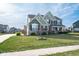 Two-story home showcasing a manicured lawn, mature trees, and charming curb appeal at 2314 Angelina Way, Greenwood, IN 46143