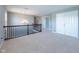 Loft with neutral carpet, iron railing, modern chandelier, and lots of space near a set of double doors at 2314 Angelina Way, Greenwood, IN 46143