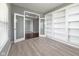 Spacious office featuring french doors, built-in shelving, and stylish tile flooring at 2314 Angelina Way, Greenwood, IN 46143