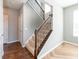 Carpeted staircase with dark wood railing and iron spindles leading to the second floor at 2314 Angelina Way, Greenwood, IN 46143