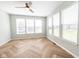 Sunny sunroom with multiple large windows and stylish herringbone flooring at 2314 Angelina Way, Greenwood, IN 46143