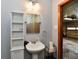 Bathroom featuring a pedestal sink, toilet and shower view to garage at 2315 Cardinal Dr, Indianapolis, IN 46227