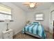 Inviting bedroom with a comfy bed dressed in blue striped bedding and abundant natural light from the windows at 2315 Cardinal Dr, Indianapolis, IN 46227