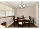 Charming dining room featuring a dark wood table set and ample natural light from the large window at 2315 Cardinal Dr, Indianapolis, IN 46227