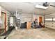 Well-lit garage featuring a water heater, furnace, and ample storage space at 2315 Cardinal Dr, Indianapolis, IN 46227