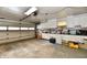 Spacious garage with ample storage cabinets, workbench, and large garage door at 2315 Cardinal Dr, Indianapolis, IN 46227