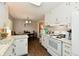 Well-lit kitchen featuring white appliances and an adjacent dining area at 2315 Cardinal Dr, Indianapolis, IN 46227
