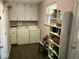 Functional laundry room with modern washer and dryer, white cabinets, and convenient storage shelves at 2315 Cardinal Dr, Indianapolis, IN 46227