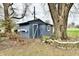 Well-maintained backyard shed with a classic design, nestled beside a mature tree at 2315 Cardinal Dr, Indianapolis, IN 46227