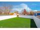 Backyard featuring a pristine green lawn enclosed by a tall, white privacy fence at 238 N Tacoma Ave, Indianapolis, IN 46201