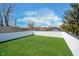 Backyard featuring a pristine green lawn enclosed by a tall, white privacy fence at 238 N Tacoma Ave, Indianapolis, IN 46201